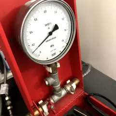 Próba szczelności instalacji wodnej powietrzem. Manometr wskazuje ciśnienie.